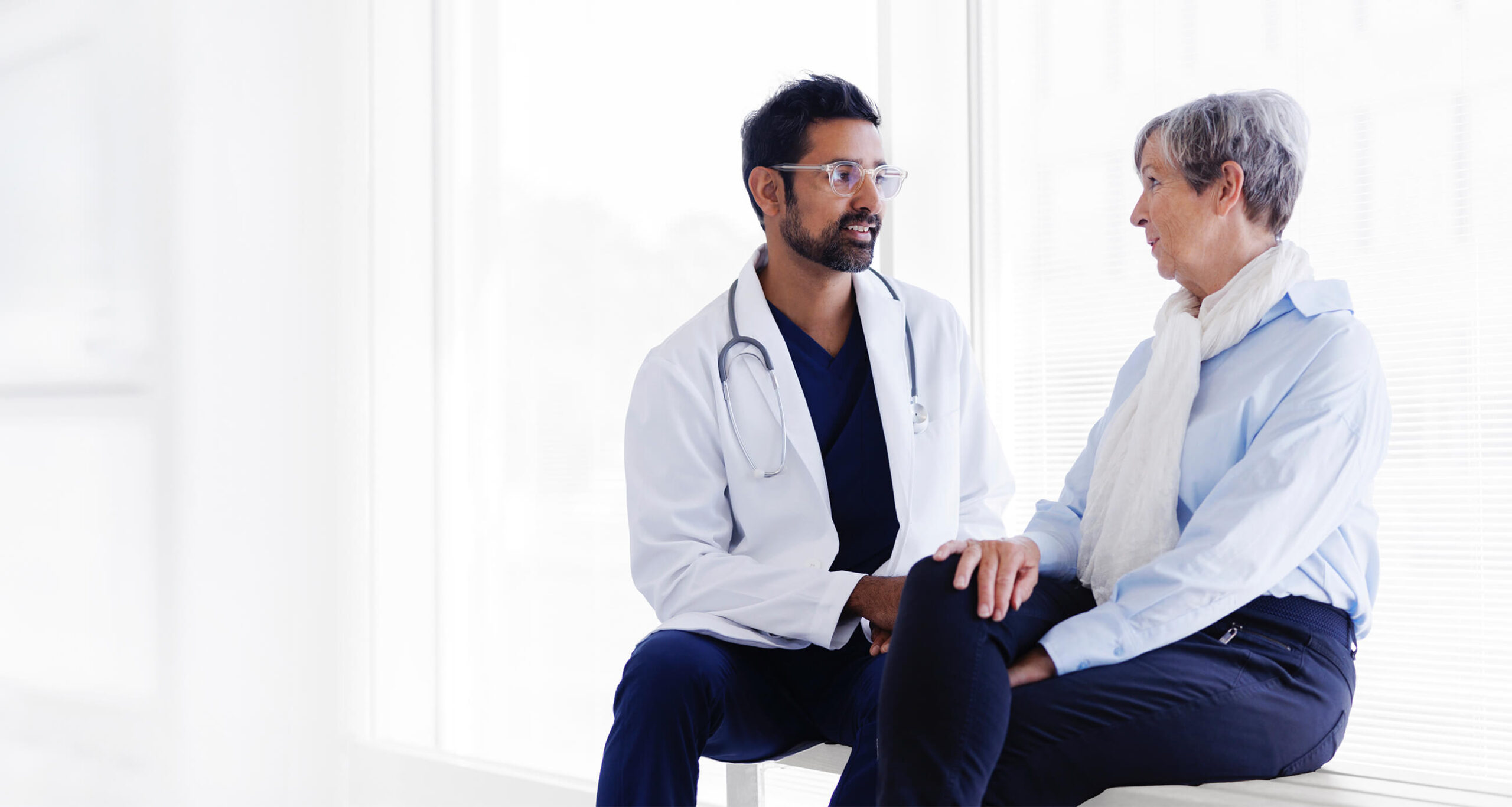 Male doctor and female patient discuss.